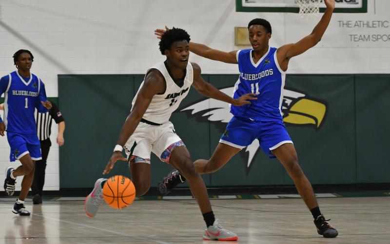 Wade Cheek/The Clayton Tribune. Eagle junior wing R.J. Lacossade battles a full-court press against New Faith Christian Academy on Nov. 30.