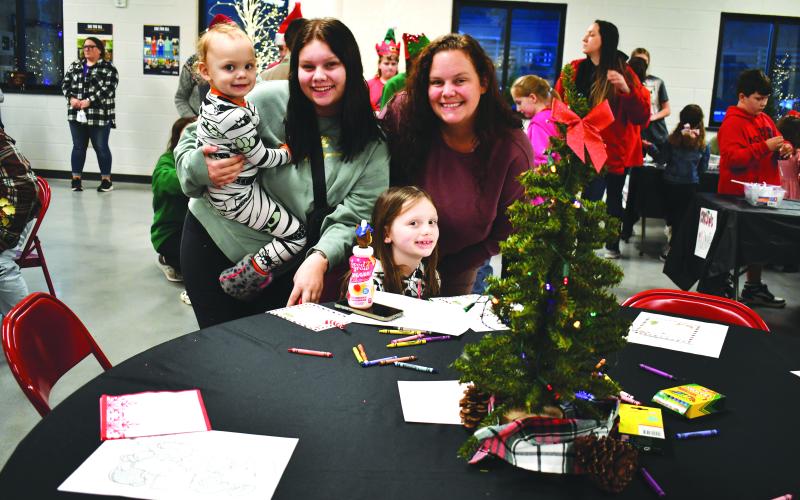 Megan Horn/The Clayton Tribune. Ashlynn Daniti and Lisa Padgett with Nevaeh Padgett, 2, and Madelynn Chapman, 7, are all smiles.