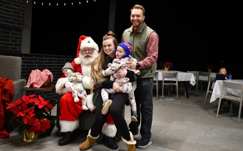 Megan Horn/The Clayton Tribune, The Stroud family of Victoria, Josh, 5-month-old Shepherd and 2-and-a-half-year-old Eden pose with Santa at Mountain Lakes Medical Center during the Dec. 14 event.