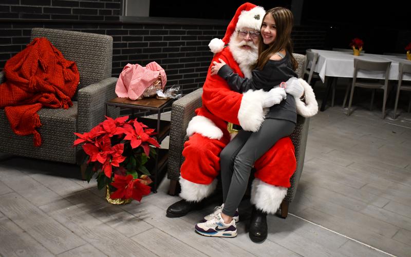 Megan Horn/The Clayton Tribune. Brooklyn Bryson, 14, sits with Santa at Mountain Lakes Medical Center Dec. 14.