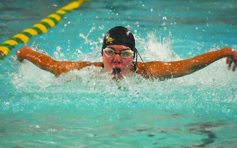 Wade Cheek/The Clayton Tribune. Rabun Gap-Nacoochee swimmer Kathryn Stribling extends her arms in a butterfly motion during the Eagles’ home meet on Friday, Dec. 1. Stribling helped lead the Lady Eagles to first place as a team.