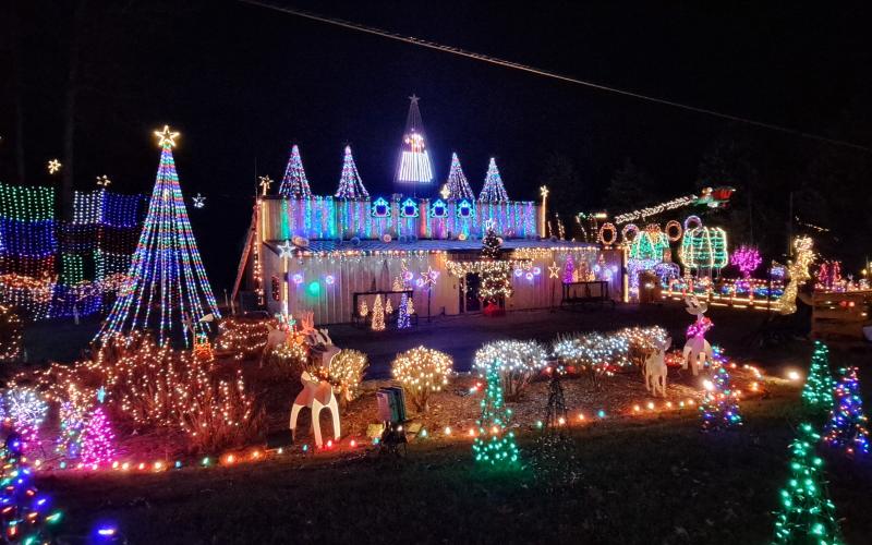 Megan Horn/The Clayton Tribune. Many decorations will be on display again this weekend at the Village of Lights.Left: Five-year-old Ethan Moseley hugs The Grinch at the Village of Lights.