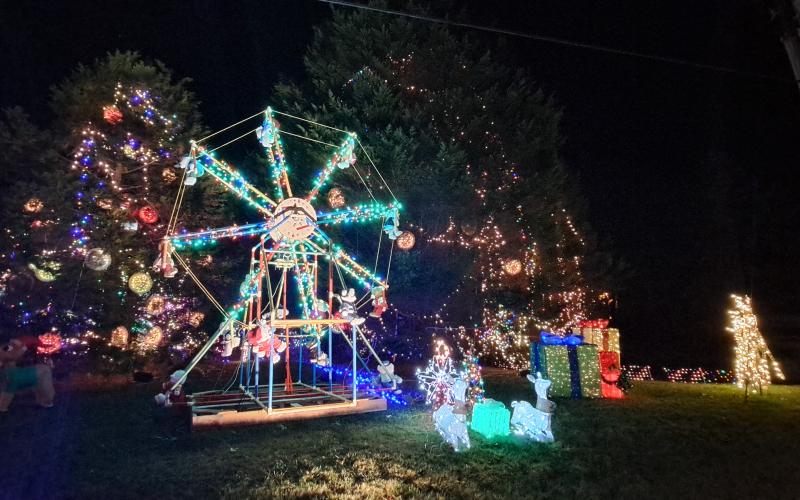 Megan Horn/The Clayton Tribune. Many decorations will be on display again this weekend at the Village of Lights.Left: Five-year-old Ethan Moseley hugs The Grinch at the Village of Lights.