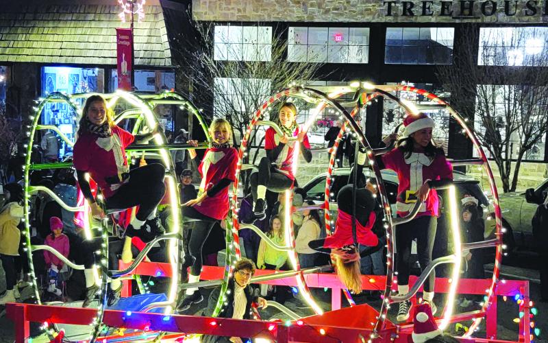 Enoch Autry/The Clayton Tribune. Rabun Gap-Nacoochee School students perform cirque maneuvers on their float in the Clayton Christmas Parade to help them win the “Best Overall” honors. The RGNS dance team also performed.