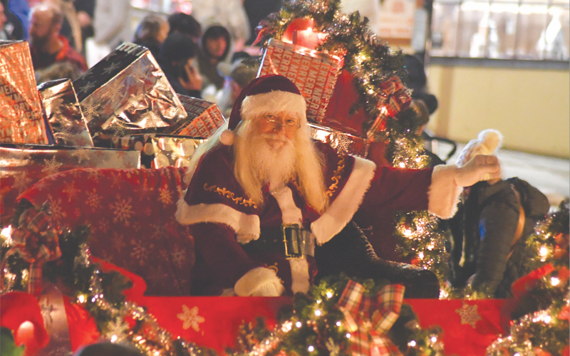 Enoch Autry/The Clayton Tribune.  Santa Claus waves from the final float in the Dec. 8 Clayton Christmas Parade on Main Street.