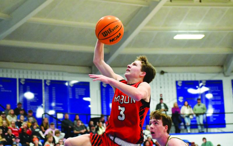 Wade Cheek/The Clayton Tribune. Sophomore standout Huey Blalock bounces a foot higher than his opponents to secure an easy layup against Hayesville on Dec. 29.