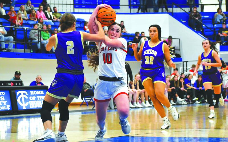 Wade Cheek/The Clayton Tribune. Lady Cat senior Mili Watts euro-steps past tough defense on her way to the basket. The Lady Cats rolled to a double-digit victory over Union County. in the BOTS championship game on Dec. 30.