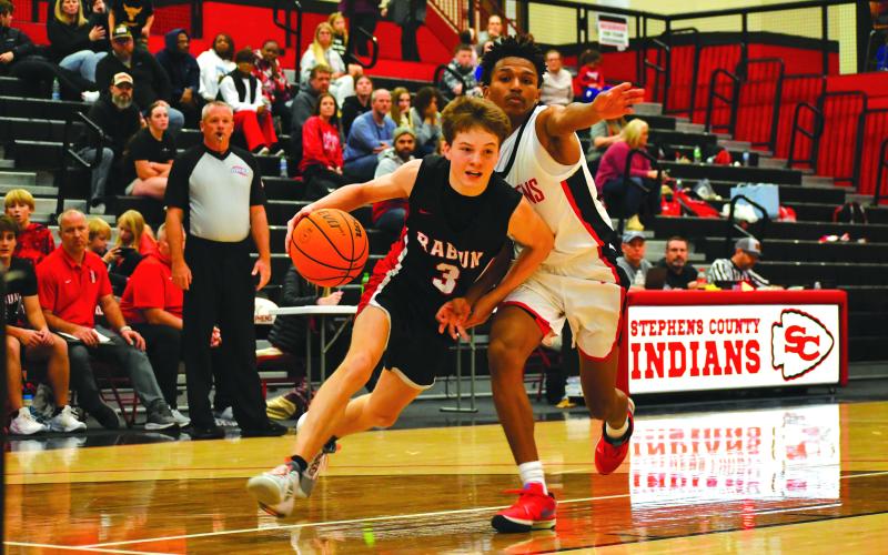 Wade Cheek/The Clayton Tribune. RCHS’s Huey Blalock drives to the hoop against Stephens County.
