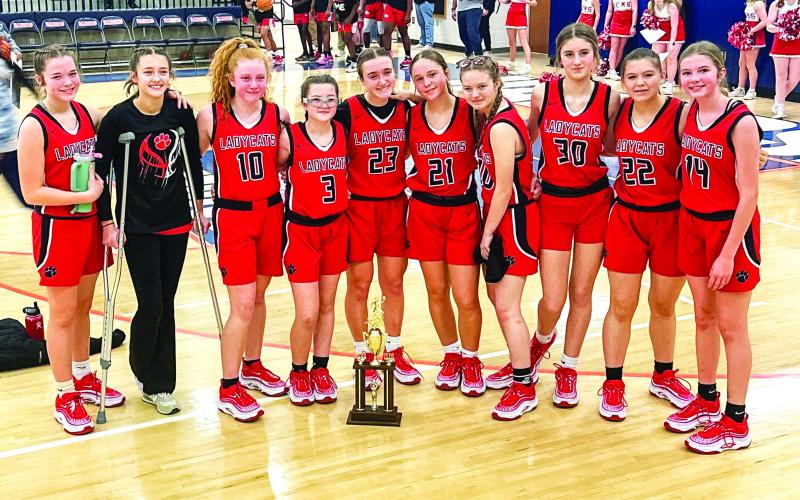 Photo provided to The Clayton Tribune. RCMS seventh and eighth-grade Lady Cats stand with their hardware after earning runner-up after last Saturday’s middle school tournament championship game. RCMS defeated Stephens County 50-20 in the semi-final but lost to Elbert County in the title game 42-36. (From left) Lady Cats Kinsey Huff, Cheyenne Queen, Irie McElroy, Maci Dixon, Millie Southards, Sophie Provance, Shay Woods, Cecelia Fields, Danni Blalock and Lydia Gergani. Melissa Weeks is the head coach.