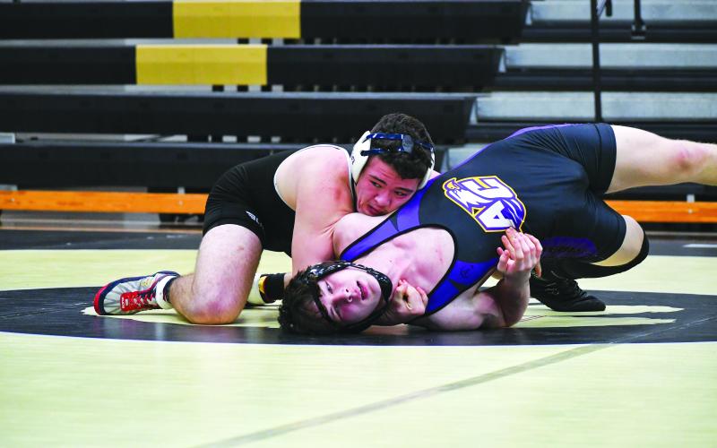 Wade Cheek/The Clayton Tribune. RCHS senior Justin Cody bends and twists his opponent from Athens Christian during the Jan. 13 area duals match last Saturday. Cody and the Wildcats will travel to Madison County today, Jan. 18 for a road dual.