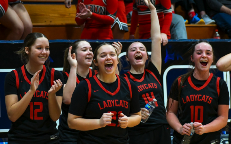 Wade Cheek/The Clayton Tribune. RCHS Lady Cat hoopers (from left) Conley Spivey, Chloe Erlewine, Loren Mazarky, Jamie McCall and Mili Watts celebrate their fellow basketball teammates from the sideline of last Friday’s region battle with Elbert County on Jan. 19. The Lady Cats have a lot to be happy about these days. As of Thursday, Jan. 25, RCHS head coach DeeDee Dillard and the Lady Cats are 16-5 and 3-1 in region play. RCHS also is currently the No. 4 team in Georgia Class A Division I.