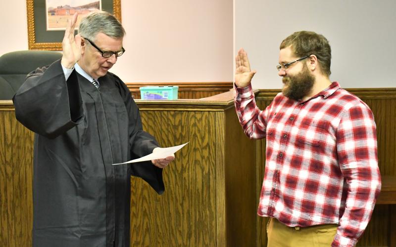 Megan Horn/The Clayton Tribune. Probate Judge Carlton Hobie Jones, III swears in Deputy Registrar Derik Pendrey.