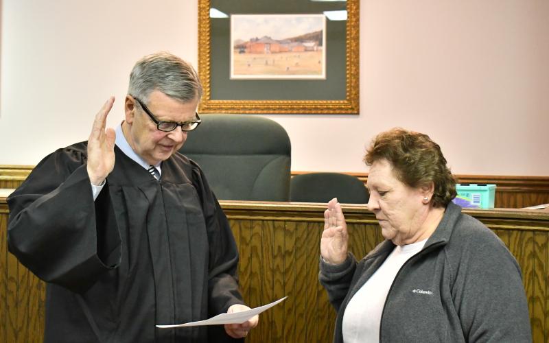 Megan Horn/The Clayton Tribune. Probate Judge Carlton Hobie Jones, III swears in Board Member Liz Dixon.
