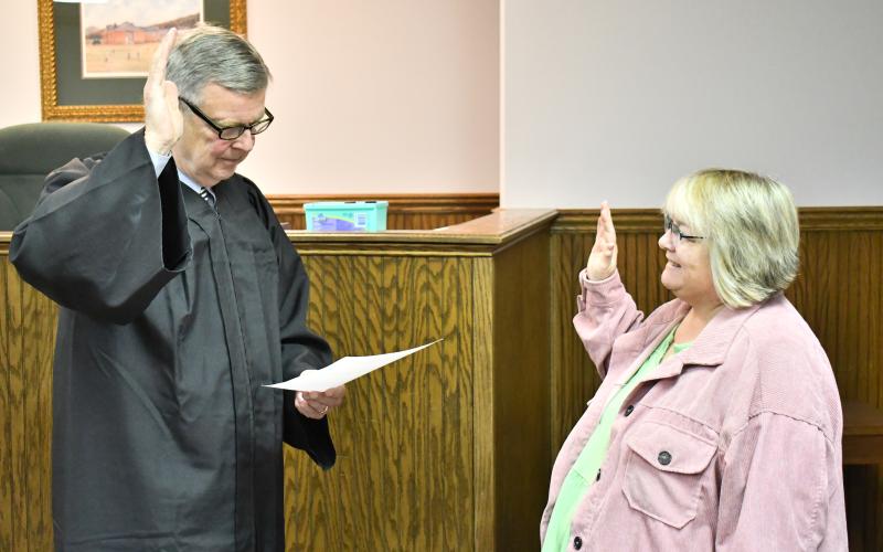 Megan Horn/The Clayton Tribune. Probate Judge Carlton Hobie Jones, III swears in Deputy Registrar Lynne Ramey.