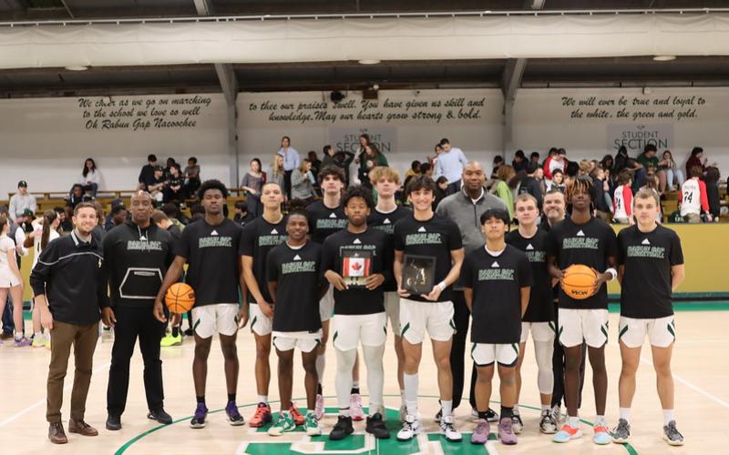 RGNS. The Eagle basketball team poses for a Senior Night photo with its two seniors.