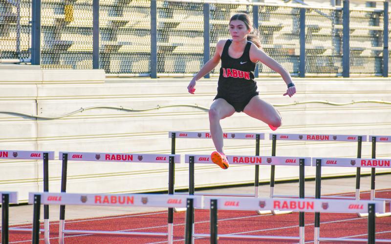 Wade Cheek/The Clayton Tribune. RCHS senior track runner Christina Keller glides through the girls 100 hurdles event during Rabun County’s season opener at Frank Snyder Memorial Stadium in Tiger on Tuesday, Feb. 20.