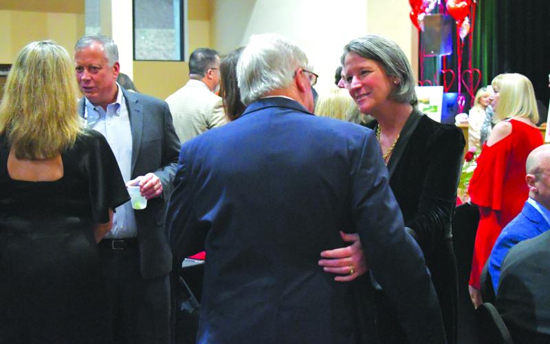 Enoch Autry/The Clayton Tribune. F.A.I.T.H. Executive Director Caroline Wallis, Bruce Russell, and F.A.I.T.H. Board of Directors Vice President Joe Lockwood chat before the start of the dinner catered by The Shed. The cash bar at the Sweetheart Ball was provided by  Universal Joint and the live music featured Party At The Limit. Left: Jim Roberson dances with his wife Susan to the live music played by the band Party At The Limit. Susan Roberson is a F.A.I.T.H. Board of Directors member.