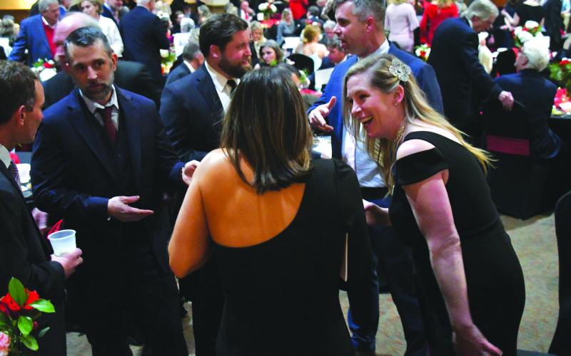 Enoch Autry/The Clayton Tribune. Scott Cheek, Chris Clay, Alex Clay, Jekka Smith, Andrew Smith and Jay Couey enjoy talking with each other at the annual F.A.I.T.H. Feb. 10 Sweetheart Ball at the Rabun County Civic Center. Jekka Smith is F.A.I.T.H.’s chief operating officer. The ball, the primary F.A.I.T.H. fundraiser, generated $100,000. Left: Jim Roberson dances with his wife Susan to the live music played by the band Party At The Limit. Susan Roberson is a F.A.I.T.H. Board of Directors member.