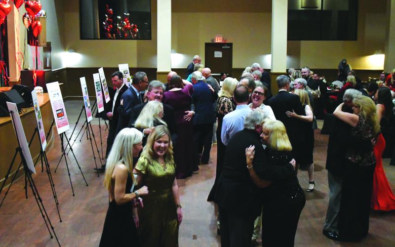 Enoch Autry/The Clayton Tribune. The 24th annual Sweetheart Ball for F.A.I.T.H. was held at the Rabun County Civic Center as the primary fundraising event to support operations of the domestic violence shelter, Power House Child Advocacy and Rape Crisis Center. ABOVE: With the Party At The Limit Band playing, couples dance while friends talk about the auction packages. Left: Jim Roberson dances with his wife Susan to the live music played by the band Party At The Limit.
