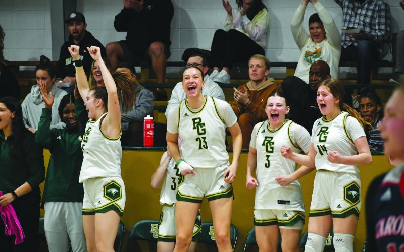 Wade Cheek/The Clayton Tribune. Rabun Gap-Nacoochee got wins over Carolina Day on Jan. 24. ABOVE: The RGNS girls celebrate their teammates’ play.