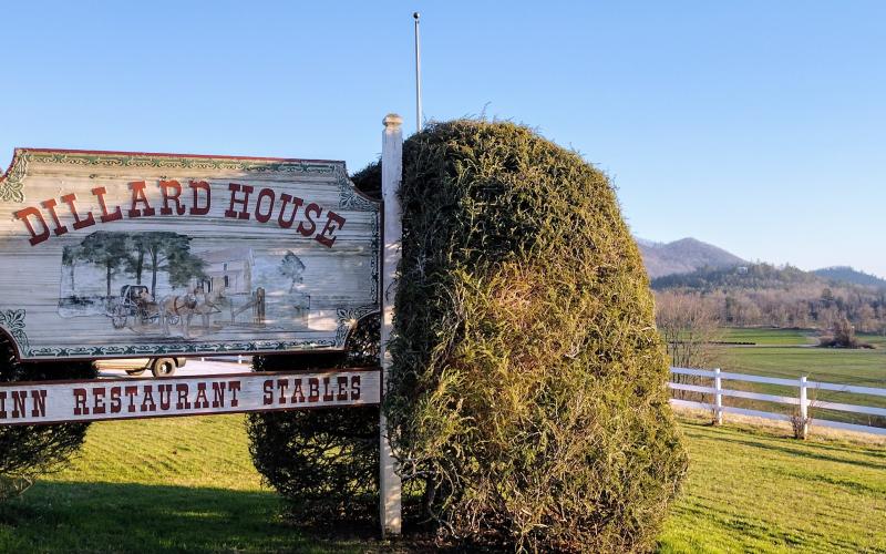 Photo courtesy of Conner Horn. Signage shows the entrance onto the property with mountains in the background.