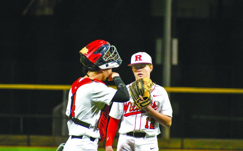 Wade Cheek/The Clayton Tribune. Rabun County pitcher and second baseman Hunter Giles has a meeting at the mound with sophomore catcher Noah English during the Wildcats’ home opener versus Union County on Feb. 14.