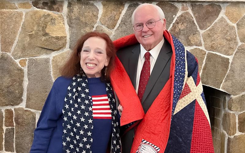 Photo courtesy of Tallulah Falls School. At the Tallulah Falls School January Board of Trustees meeting, board member Alice Cookie Noel, a member of the Quilts of Valor committee for South Central Georgia and for the Lake Oconee Quilt Guild, presented President and Head of School Dr. Larry A. Peevy with a quilt created by Kathy Henderson, a member of the Lake Oconee Quilt Guild.