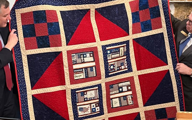 Photo courtesy of Tallulah Falls School. The  Lake Oconee Quilt Guild presents Tallulah Falls School President and Head of School Dr. Larry A. Peevy with a quilt.