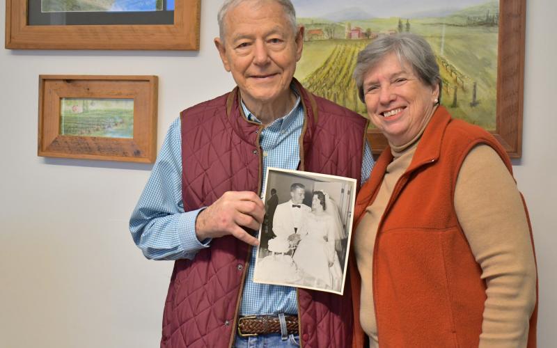 Megan Horn/The Clayton Tribune. Dr. Tom and Becky Callahan reminisce on their 63 years of marriage together as they hold a picture from their wedding day on June 18, 1960. The couple was married at Trenton Street Baptist Church in Harriman, Tenn.