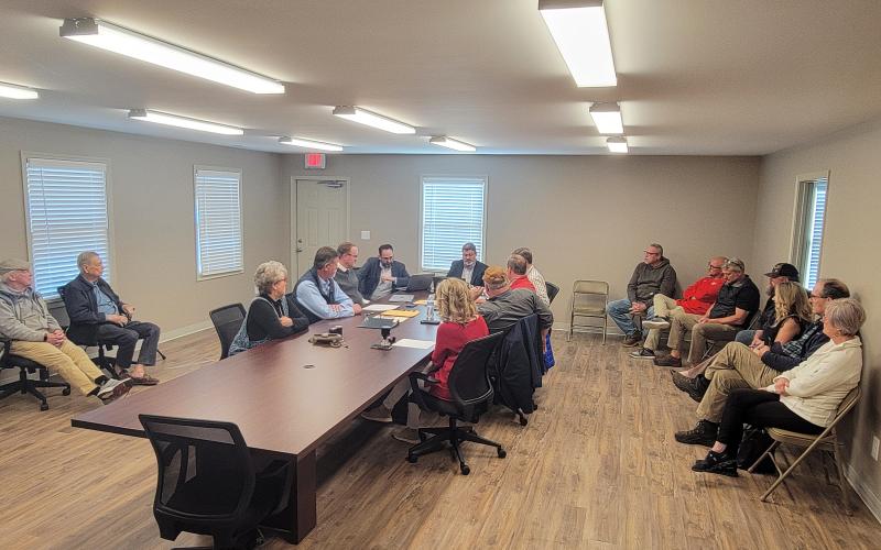 Enoch Autry/The Clayton Tribune. Officials from the City of Clayton and Rabun County meet Monday morning for the closing of the consolidation of water and sewer with the Rabun County Water and Sewer Authority (RCWSA).