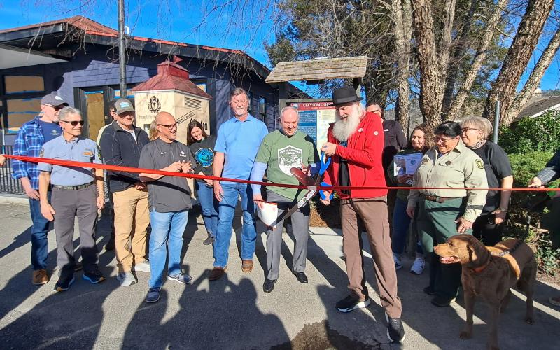 Megan Horn/The Clayton Tribune. Forward Rabun/Rabun County Chamber of Commerce cuts the ribbon on the new Appalachian Trail (AT) Community Kiosk located near the Rock House on Main Street in Clayton March 7. Community citizens, officials from the City of Clayton and county, and AT Community Committee members participated in the event.