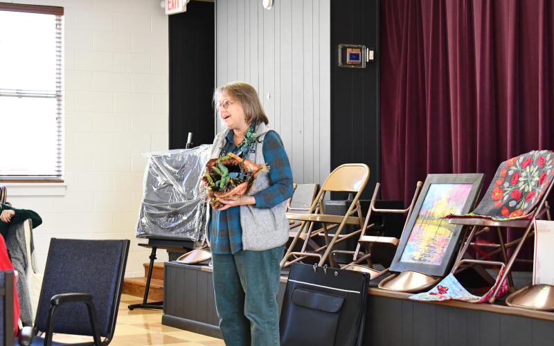 Megan Horn/The Clayton Tribune. Helen Rogers shows her piece titled “Shrine of the shark god Malachi” with the inspiration from the movie “Jaws” during the North Georgia Arts Guild “Show and Tell” showcase Feb. 15.