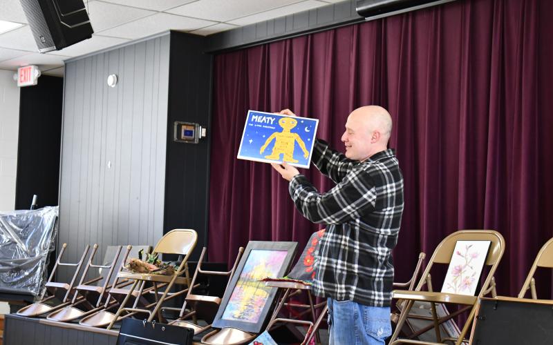 Megan Horn/The Clayton Tribune. Guild member Eric Hollifield had a clever twist on the movie “E.T. the Extra-Terrestrial” with his painting titled “Meaty: The X-Tra Digestible.”