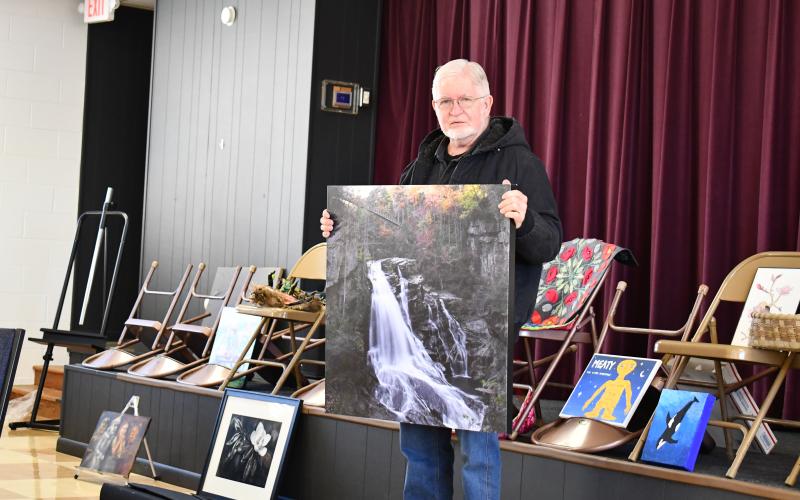 Megan Horn/The Clayton Tribune. Danny Young discussed his waterfall picture and the challenges he went through to capture the perfect view of a place where kayakers descend on a November weekend. A portion of the movie “Deliverance” was filmed there.