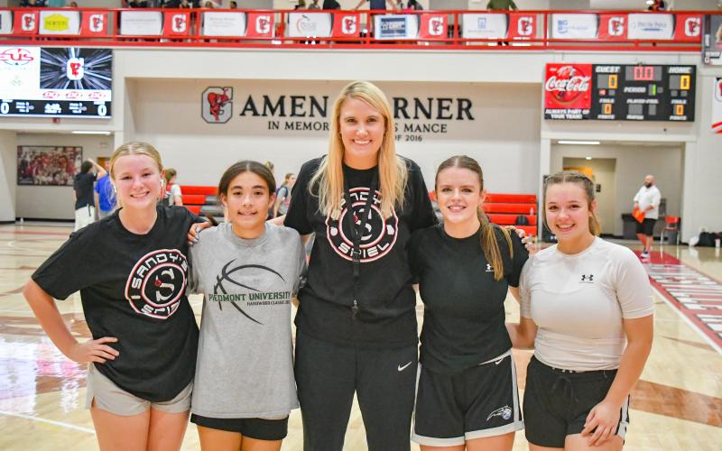 Wade Cheek/The Clayton Tribune. Rabun County Lady Cats assistant coach Mackenzie Darrah poses for a photo with RCHS players Kenlee Hedge, Addybeth Owens, Adelyn Thompson and Loren Mazarky at the Sandy’s Spiel Showcase. Darrah was one of the coaches at the showcase and the four Lady Cats played at the event. Other locals in the showcase were Sofia McNabb of Rabun Gap-Nacoochee School and Breelyn Wood of Tallulah Falls School.