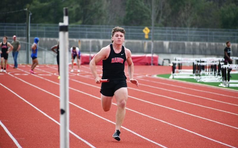 Wade Cheek/The Clayton Tribune. Wildcat track and field runner Dane Tyler sprints to the finish during one of the relay events at the ninth-annual Bo James Invitational.