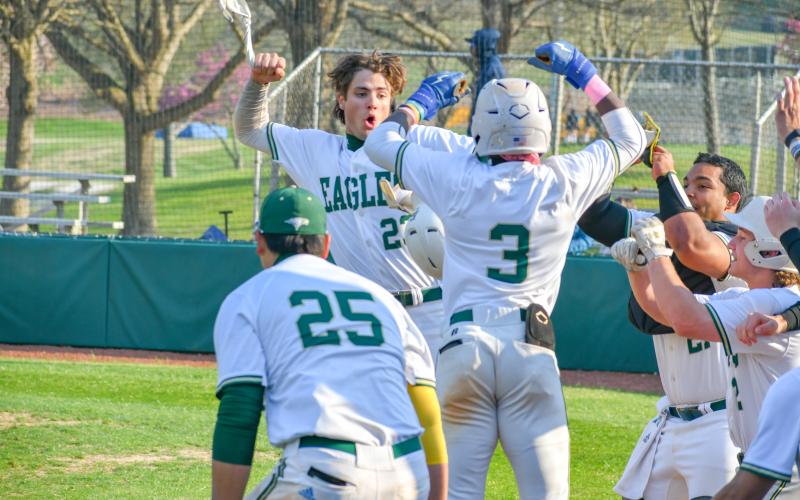 Wade Cheek/The Clayton Tribune. RGNS junior outfielder Jeremy Ramos celebrates with his Eagle teammates after hitting one of his four home runs during Rabun Gap’s 23-0 win over Carolina Day School on Tuesday, March 19.