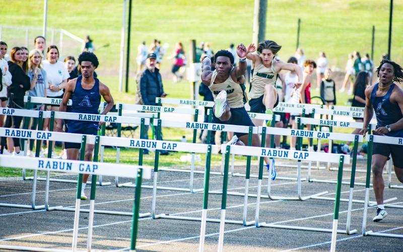 Wade Cheek/The Clayton Tribune. RGNS track and field hurdler Josh Buckhalter strides over a barrier to win the boys 110 meter hurdles during Rabun Gap’s home meet last Wednesday, March 20.