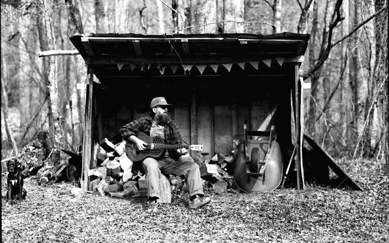Photo courtesy Ronnie Pettit. This black-and-white photograph by Ronnie Pettit shows Rabun County resident Scott Low as he promotes his new album “Appalachian Blues.” Low has release parties scheduled in three states.