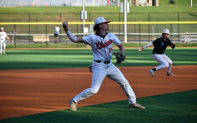Wade Cheek/The Clayton Tribune. Diamond 'Cat senior Cooper Welch slings a throw to first base for an out during the Wildcat's game against Towns County on Friday, April 19.