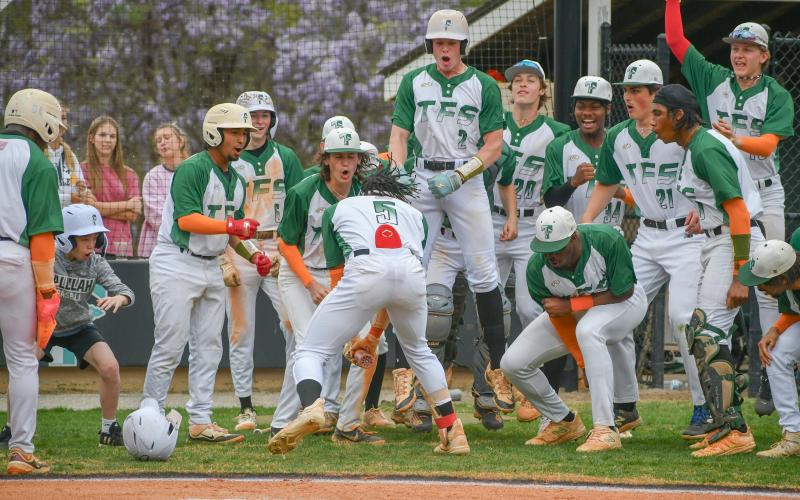 Wade Cheek/The Clayton Tribune. TFS baseball junior Danny Vigille-Grant slams his bat down in celebration with his teammates after his second home run during a Region 8 win over Rabun County High School. The Indians and Wildcats will face off two more time on Friday, April 5 during a double-header in Tiger.