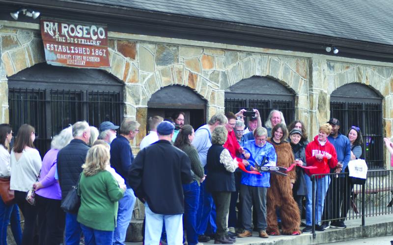 Enoch Autry/The Clayton Tribune. Dr. John Stamey cuts the ribbon for Forward Rabun and Rabun County Chamber of Commerce.