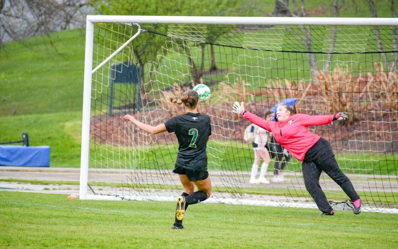 Wade Cheek/The Clayton Tribune. RGNS senior forward Georgia Mattis watches her first of three goals pierce the net during a cross-county match against Tallulah Falls School on Tuesday, April 9. Rabun Gap improved to 10-2.