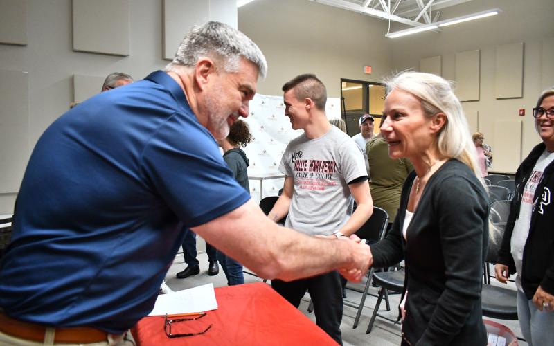 Megan Horn/The Clayton Tribune. Rep. Victor Anderson, left, shakes hands with Clerk of Superior Court Holly Henry-Perry.