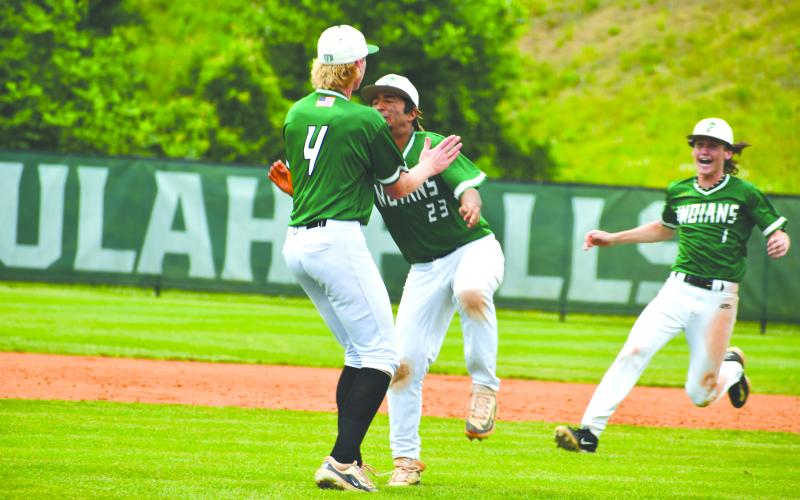 Wade Cheek/The Clayton Tribune.  TFS junior Justin Pollock lifts up his senior teammate Diego Gonzalez in celebration after the Indians defeated Swainsboro 7-6 to advance to the Final Four of the state tournament for the first time in school history.