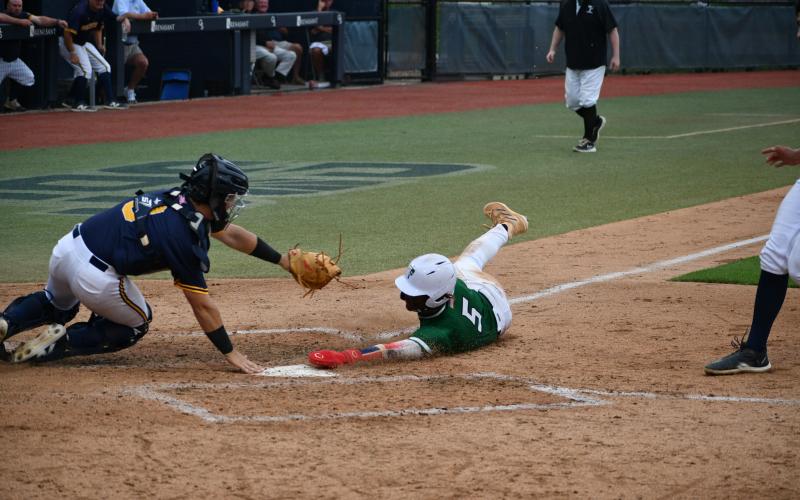 Wade Cheek/The Clayton Tribune. ABOVE: Talluah Falls School junior outfielder Danny Grant extends his hand into home plate for a run in the state title but is called out after a controversial call that helped Prince Avenue come back and win Game One of this year’s Class A D-I state title.