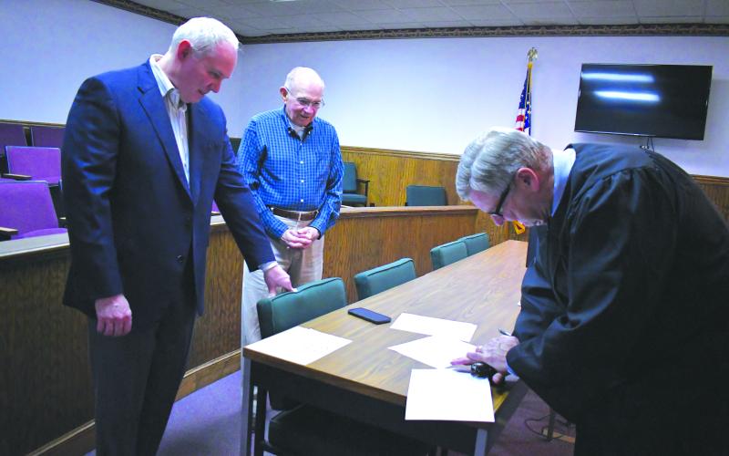 Enoch Autry/The Clayton Tribune. Rabun County Probate Judge Hobie Jones swears-in Rick Story as the newest member of the Rabun County Board of Education Tuesday, May 7.
