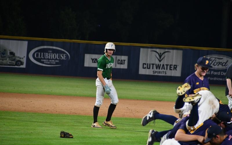 Wade Cheek/The Clayton Tribune. ABOVE: Indian baseball junior Chase Pollock watches the Wolverines of Prince Avenue celebrate after they defeated Tallulah Falls School in the Georgia Class A D-I state championship.
