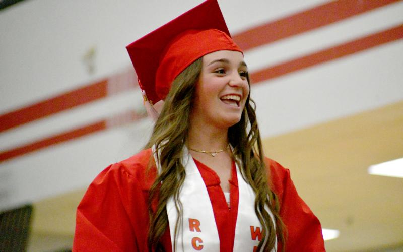 Wade Cheek/The Clayton Tribune. Mili Watts smiles as she walks across the stage, receiving her high school diploma at Rabun County High School’s graduation on Friday, May 24. Watts will attend Winthrop University where she will also play softball.