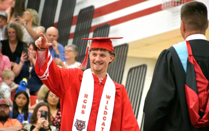 Wade Cheek/The Clayton Tribune. RCHS 2024 senior Cooper Welch points out to the cheering crowd as he collects his high school diploma at the RCHS graduation on Friday, May 24. Welch will attend Georgia Southern University.